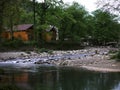 The clear creek in the forest, the wooden house next to the creek