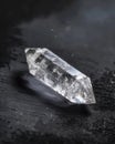 Clear crystal on dark surface in natural light Royalty Free Stock Photo
