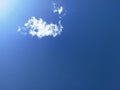 Clear, deep blue sky with a single white cloud floating near the top left. Royalty Free Stock Photo