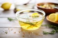 clear detox broth with floating herbs and lemon slices, detoxifying