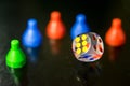 A clear dice and tokens in a reflective surface Royalty Free Stock Photo