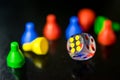 A clear dice and tokens in a reflective surface Royalty Free Stock Photo