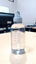 Clear Drinking Bottle on a light brown wooden table