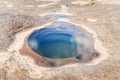 Clear emerald green water inside the hole rock