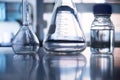 Clear flask and water in the bottle in medical science laboratory background