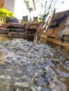 A clear fountain falling into a pool of water Royalty Free Stock Photo