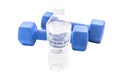 Clear full water bottle and ywo blue dumbell weights isolated on