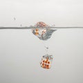 Clear game dice drop in clear water with a splash Royalty Free Stock Photo
