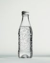 A clear glass bottle filled with sparkling water, showcasing bubbles and a metallic cap Royalty Free Stock Photo
