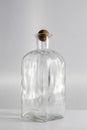 Clear glass bottle, with round cap