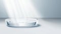 A clear glass bowl sits on a white surface, illuminated by a light source from above. Royalty Free Stock Photo