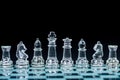 Transparent glass chess pieces arranged in a row reflecting in glass chessboard. Isolated on black Royalty Free Stock Photo