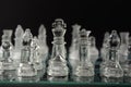 Clear glass chess pieces on a glass chessboard Royalty Free Stock Photo