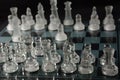 Clear glass chess pieces on a glass chessboard Royalty Free Stock Photo