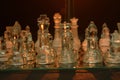 Clear glass chess pieces on a glass chessboard Royalty Free Stock Photo