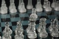 Clear glass chess pieces on a glass chessboard isolated Royalty Free Stock Photo