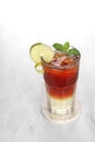 A clear glass containing ice lemon tea with garnish of lemon slices and mint leaves Royalty Free Stock Photo