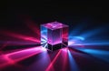 Clear glass cube refracts pink and blue light beams. Geometric prism casts colorful rays on dark surface. Abstract optical Royalty Free Stock Photo