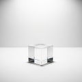 A clear glass cube rests on a smooth, white surface, casting subtle shadows Royalty Free Stock Photo