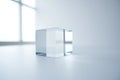 Clear glass cube on white surface, sharp edges, geometric shape, bright studio light, simple form Royalty Free Stock Photo