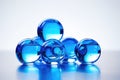 a clear glass filled with shiny blue marbles Royalty Free Stock Photo