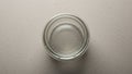 A clear glass filled with water is placed on a light textured surface Royalty Free Stock Photo
