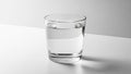 Clear glass filled with water resting on a smooth white surface Royalty Free Stock Photo