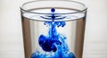 Glass filled with water showcases a striking visual of blue ink Royalty Free Stock Photo