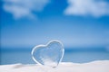 Clear glass heart on white sand beach glitter glass and reflec Royalty Free Stock Photo