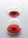 Clear glass hourglass with red sand Royalty Free Stock Photo