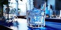 A clear glass with ice on the kitchen table. The concept of osmotic water purification