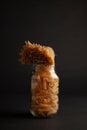 Clear glass jar containing raw pasta with tied pasta on top Royalty Free Stock Photo