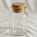 A clear glass jar with a cylindrical shape and smooth surface, sealed with a round Royalty Free Stock Photo