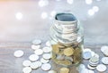 A clear glass jar filled with cash and coins Royalty Free Stock Photo