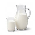 Clear glass pitcher and a glass with cow\'s milk, isolated on a white Royalty Free Stock Photo