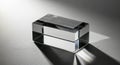 Clear glass rectangular prism refracting light and casting shadows on a textured surface Royalty Free Stock Photo