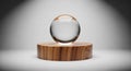 A clear glass sphere is displayed atop a cylindrical wooden pedestal with a rich Royalty Free Stock Photo