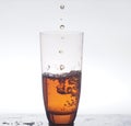 In a clear glass stream poured drink. Photo on a white background.