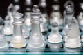 glass, transparent chess pieces on a checkerboard, selective focus, close-up, isolated on black Royalty Free Stock Photo