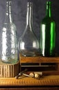 CLEAR AND GREEN GLASS BOTTLES WITH VINTAGE CORKSCREW AND CORKS Royalty Free Stock Photo