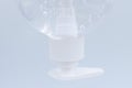 Clear hand sanitizer in a clear pump bottle isolated on a white background