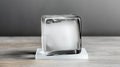 Clear ice cube showcasing unique textures and reflections on a simple surface Royalty Free Stock Photo
