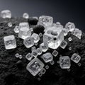 Clear ice cubes with visible air bubbles are scattered on a textured black surface, Royalty Free Stock Photo