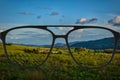 Clear image in glasses against blurry landscape