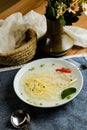 Clear Lemon Chicken Wonton include noodles, spring onion and red pepper served in bowl isolated on napkin side view of chinese