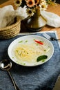 Clear Lemon Chicken Wonton include noodles, spring onion and red pepper served in bowl isolated on napkin side view of chinese