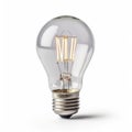 a clear light bulb with a dim light inside of it on a white background with a shadow of the bulb on the side of the light bulb Royalty Free Stock Photo