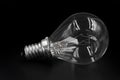 Clear light bulb lying on side on black background Royalty Free Stock Photo
