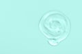 Clear gel drop or smear isolated on light blue background. Copy space Royalty Free Stock Photo