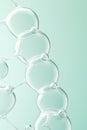 Clear liquid spheres interconnected, forming a delicate molecular chain pattern against a soft green backdrop, illustrating Royalty Free Stock Photo